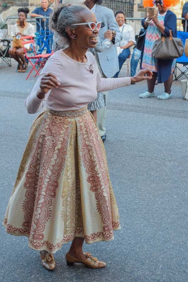 Une voyageuse senior se promène, joyeuse, dans une rue animée